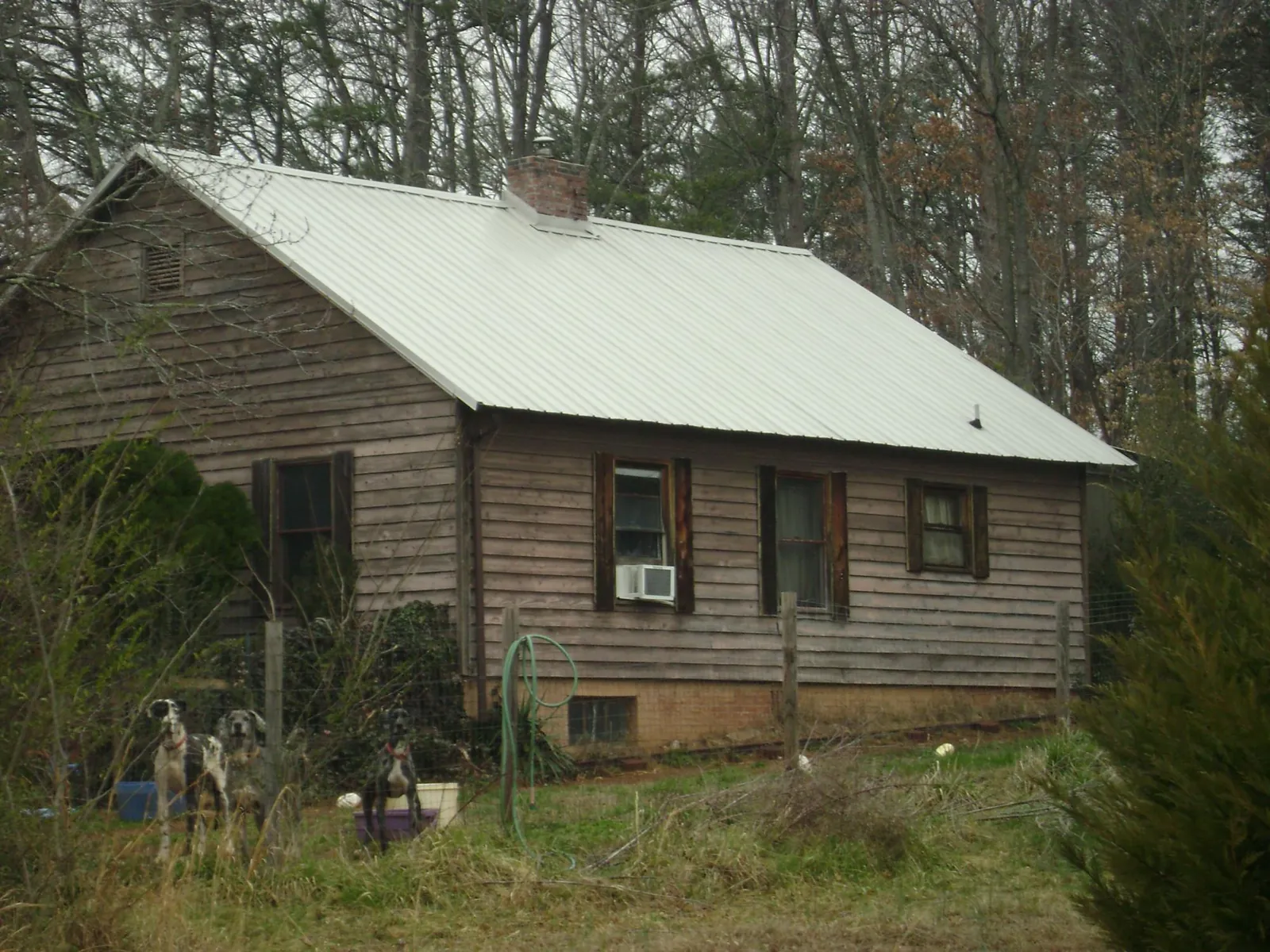 White metal roof on an old wood sided farmhouse, from a Metal Roof Installation job in Saint Louisville