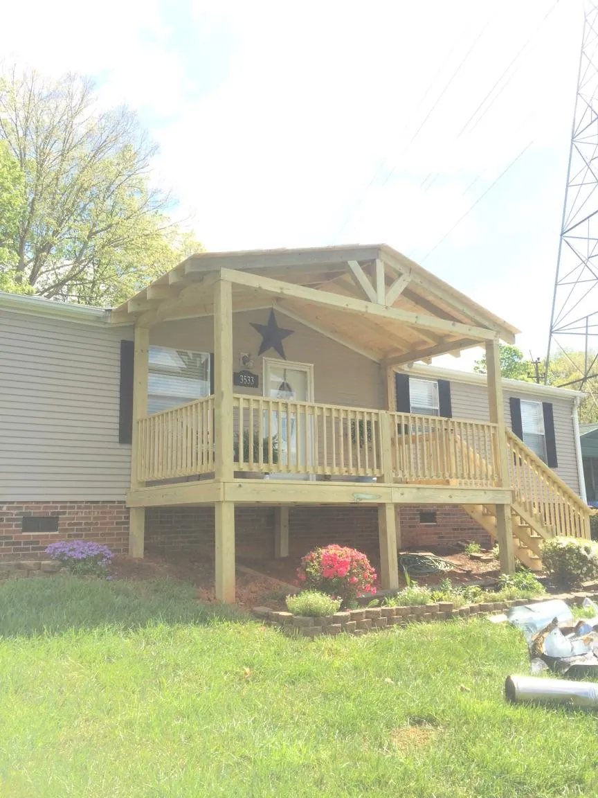 New gabled porch roof and deck railing added to a ranch home in Saint Louisville